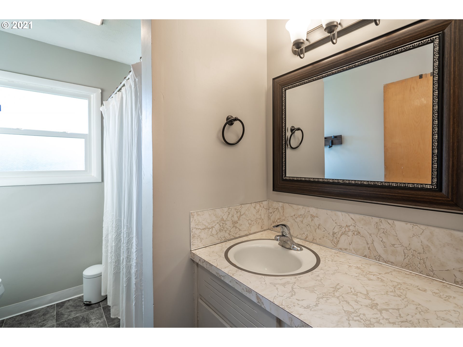 1367 Olympic Street Springfield, OR 97477 - Photo 16 of 20 a bathroom with a toilet a sink and mirror