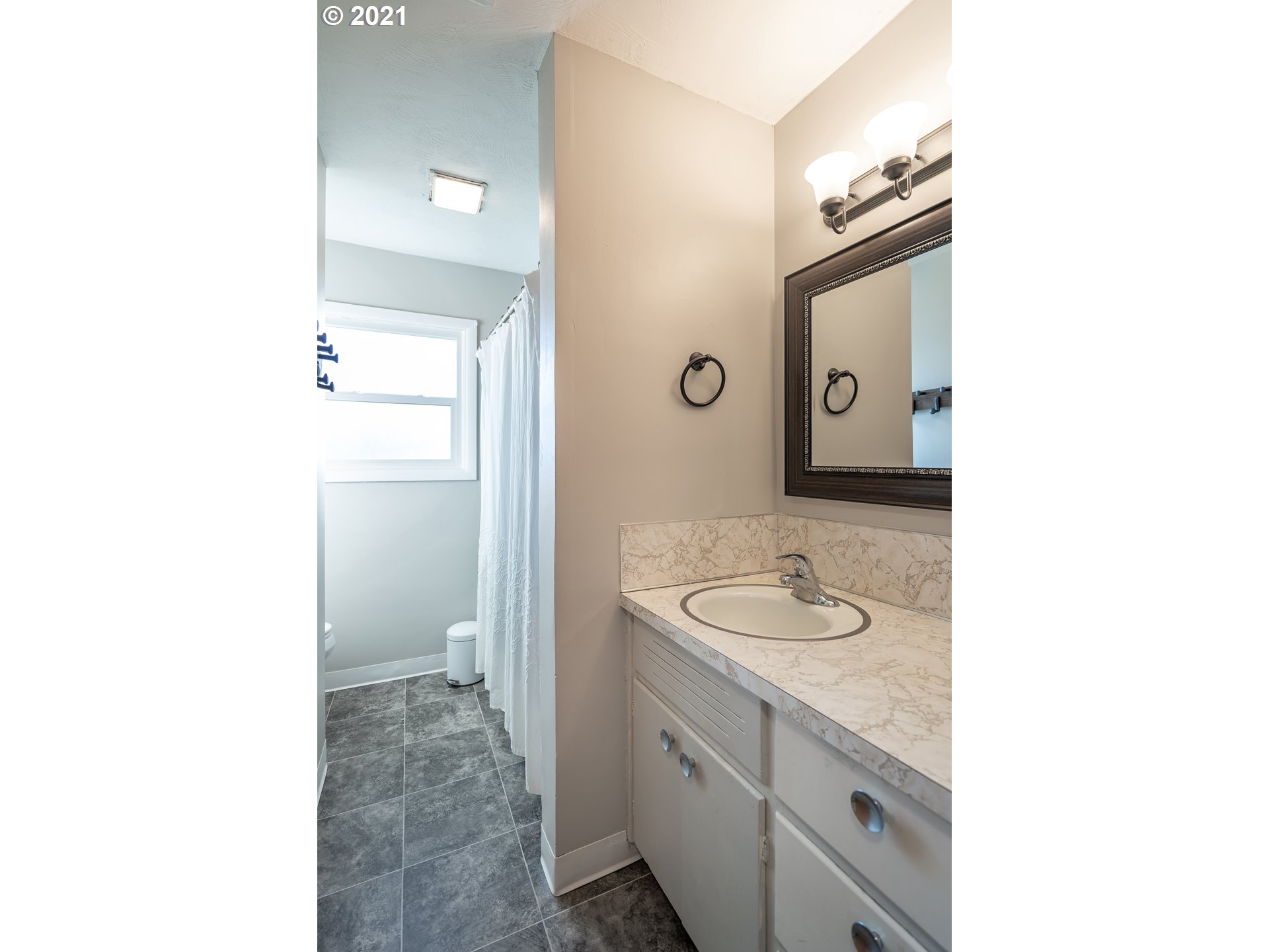 1367 Olympic Street Springfield, OR 97477 - Photo 17 of 20 a bathroom with a granite countertop sink a mirror and a toilet