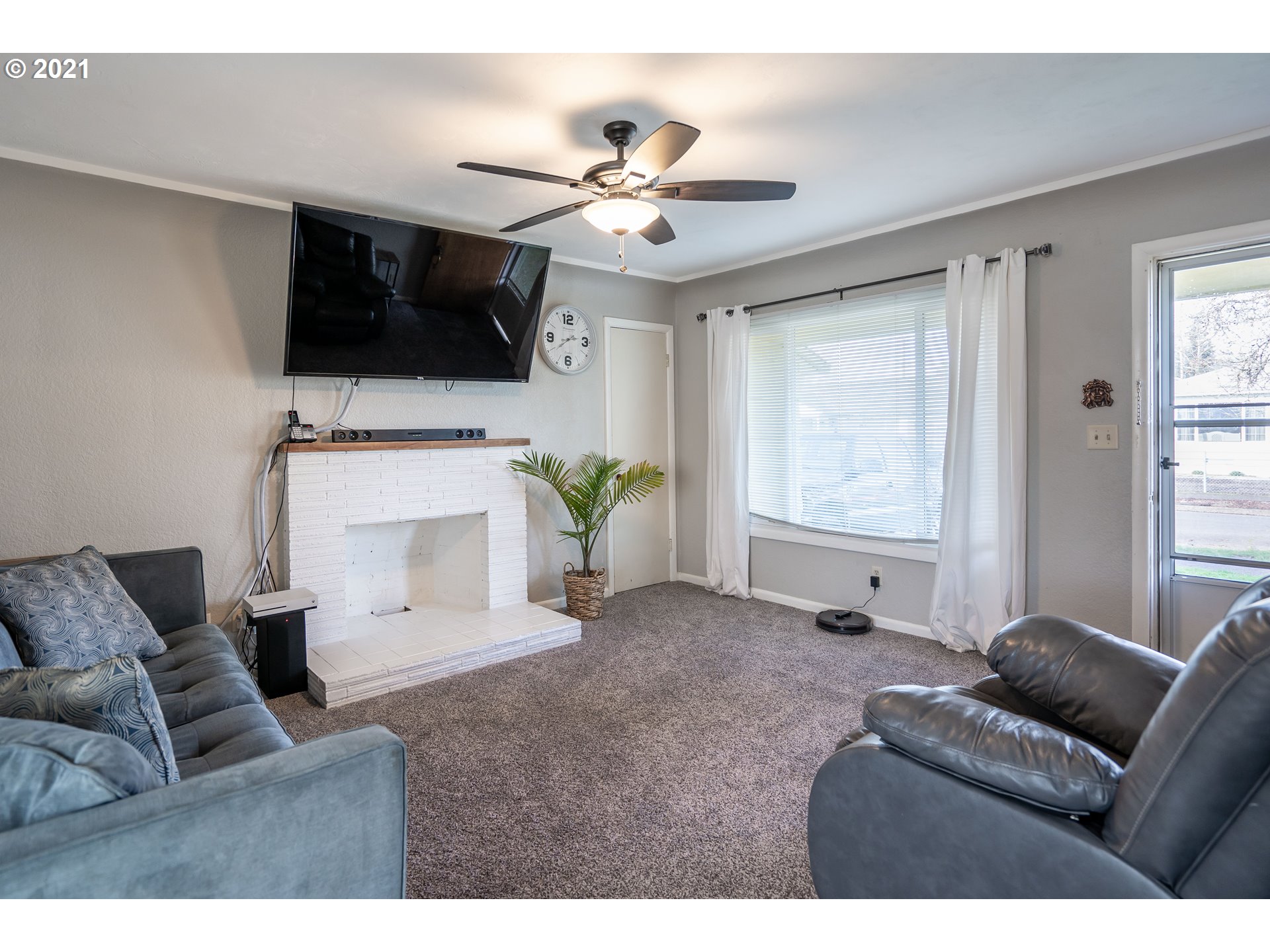 1367 Olympic Street Springfield, OR 97477 - Photo 2 of 20 a living room with furniture and a flat screen tv