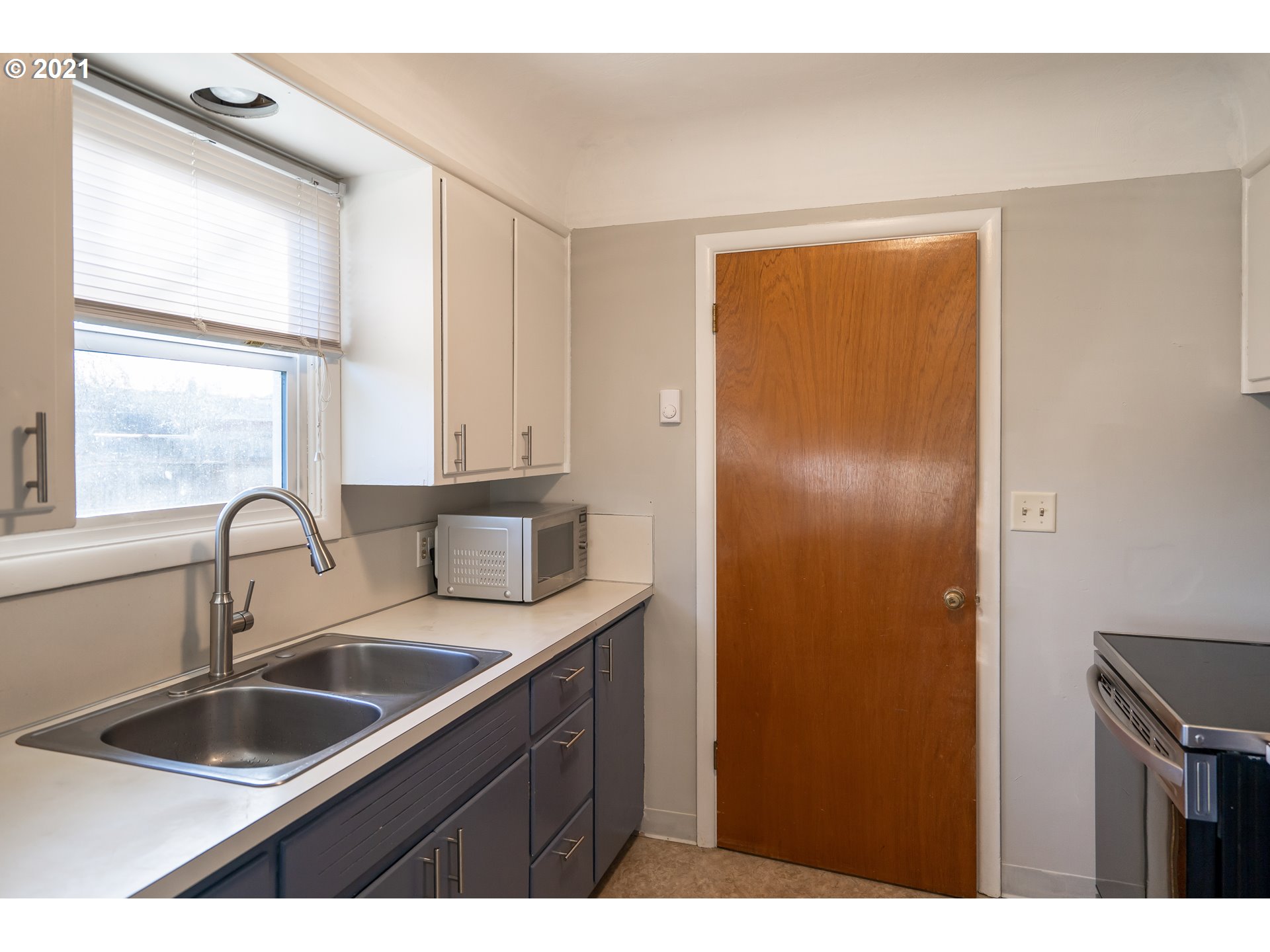 1367 Olympic Street Springfield, OR 97477 - Photo 8 of 20 a kitchen with a sink a refrigerator and window