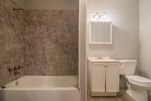 a bathroom with a sink a toilet and bathtub