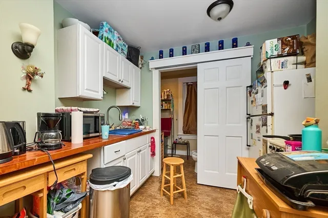 a kitchen with a refrigerator and a sink