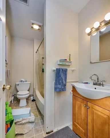 a bathroom with a tub sink and mirror
