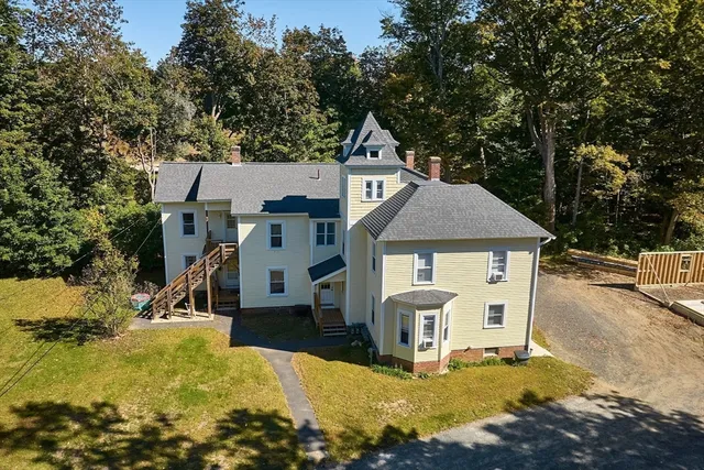 an aerial view of a house with a yard basket ball court and outdoor seating