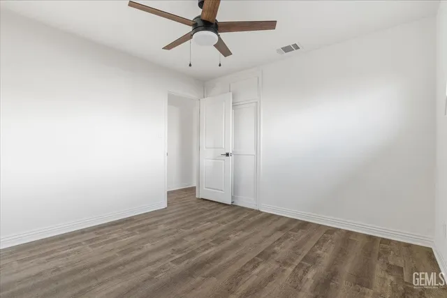 a bathroom with a granite countertop sink mirror vanity and toilet