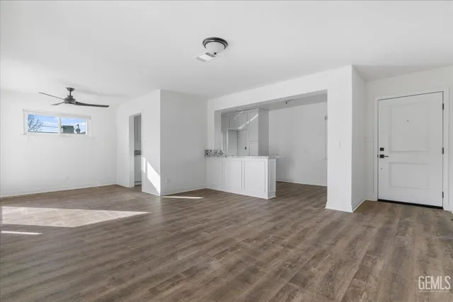 a view of empty room with wooden floor