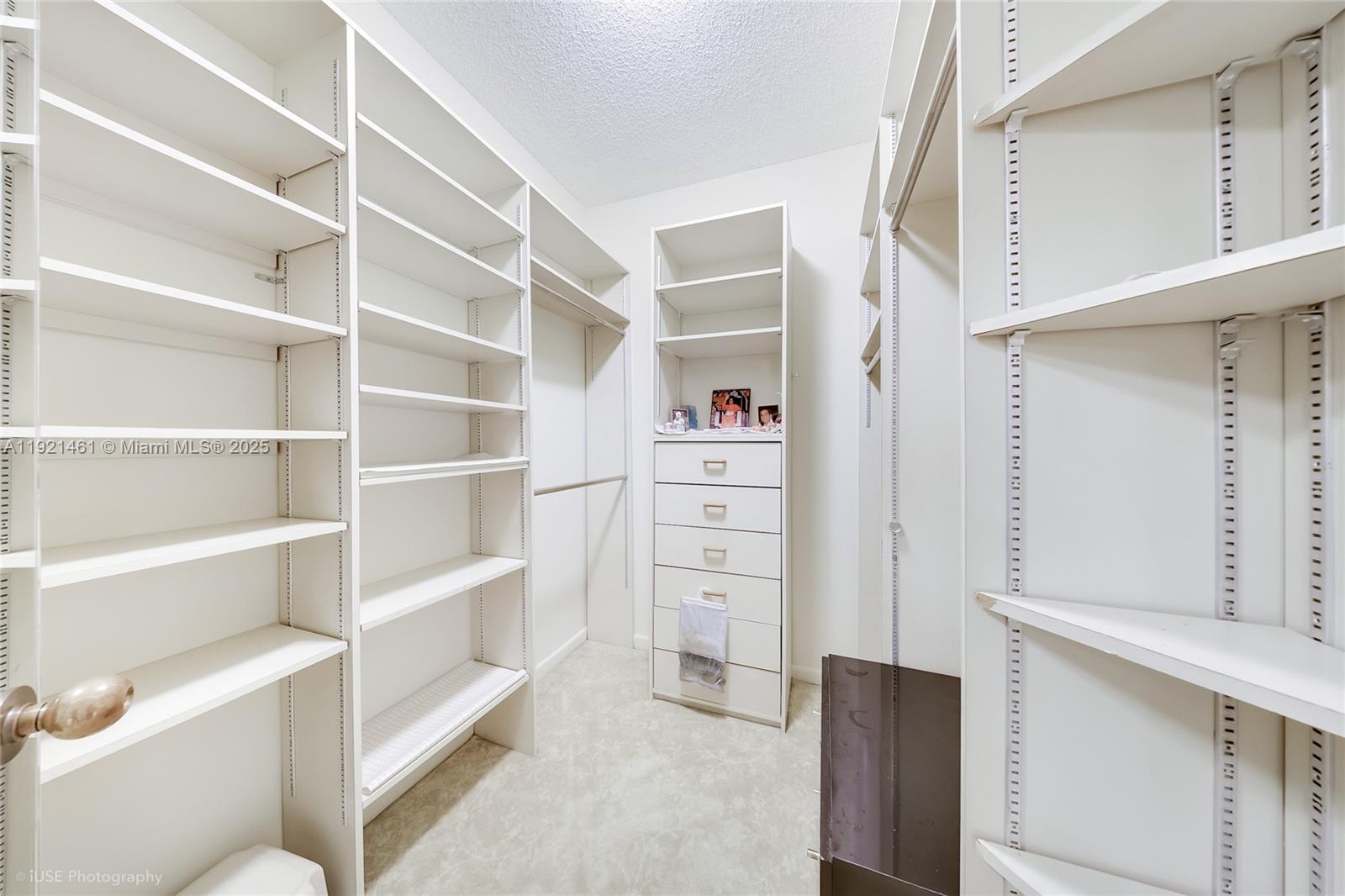 520 Brickell Key Drive, Unit A1510 Miami, FL 33131 - Photo 11 of 15 a view of walk in closet with empty racks