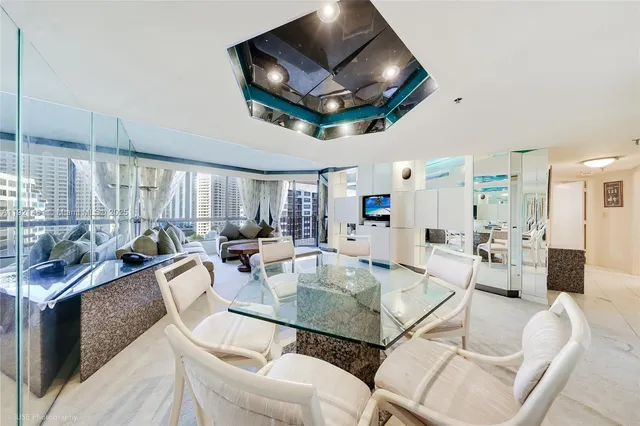 a view of a dining room with furniture a chandelier and wooden floor