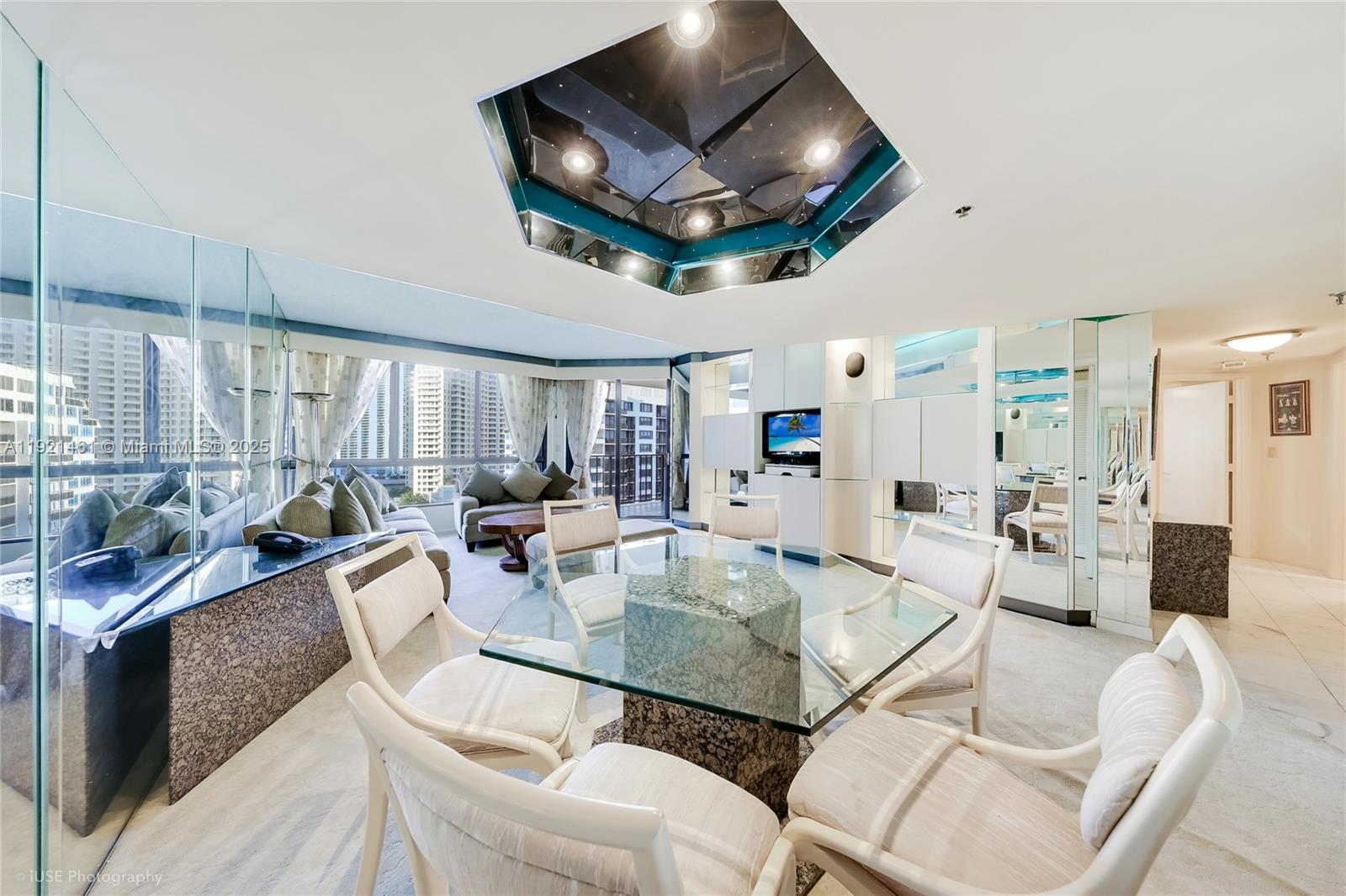 520 Brickell Key Drive, Unit A1510 Miami, FL 33131 - Photo 6 of 15 a view of a dining room with furniture a chandelier and wooden floor