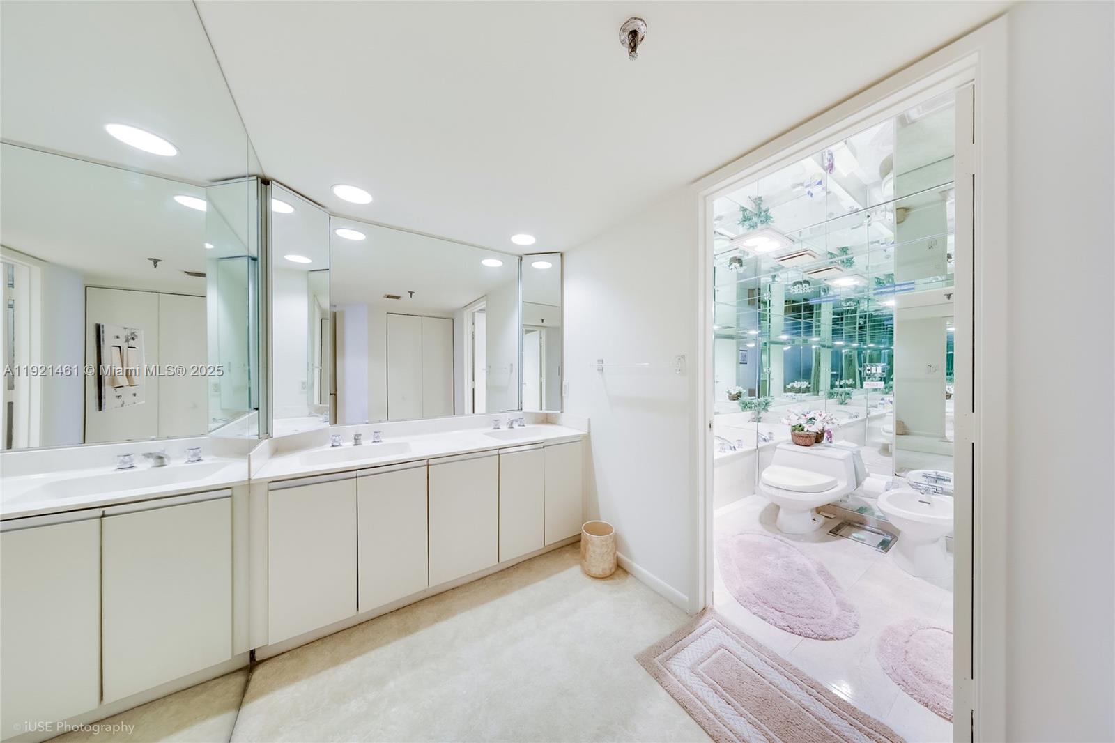 520 Brickell Key Drive, Unit A1510 Miami, FL 33131 - Photo 10 of 15 a bathroom with a double vanity sink and mirror