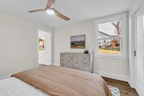 a bedroom with a bed and a painting on the wall