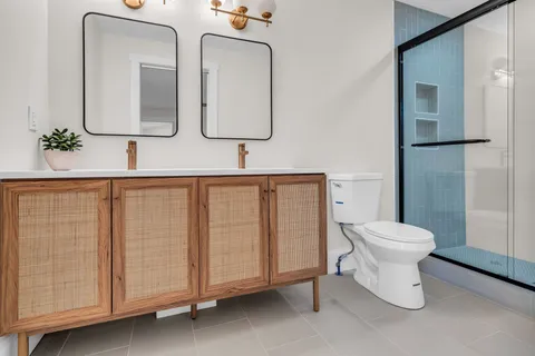 a bathroom with a toilet sink and mirror