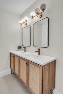 a bathroom with a double vanity sink and a mirror
