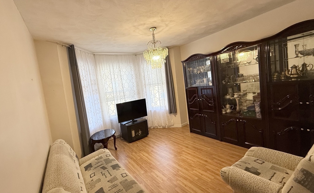 92 Gordon Street, Unit 301A Boston, MA 02135 - Photo 5 of 15 a view of a livingroom with furniture and a flat screen tv