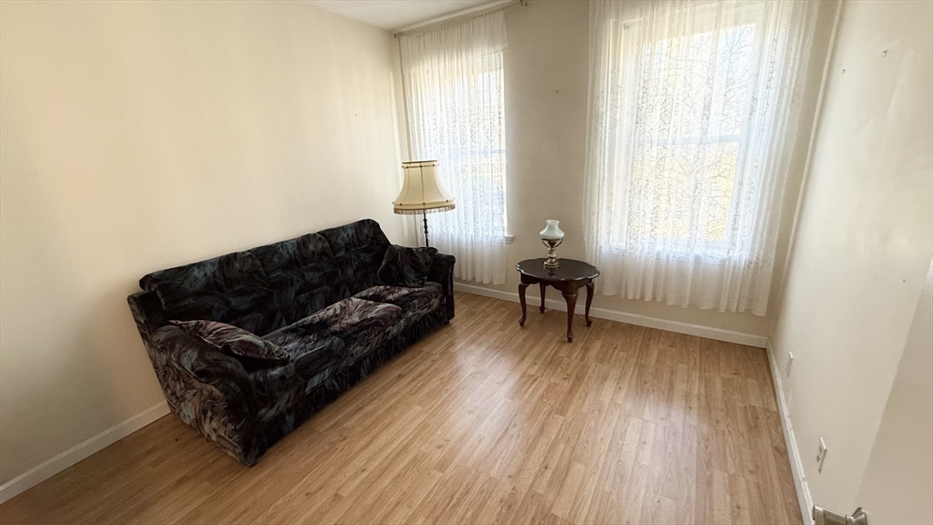 92 Gordon Street, Unit 301A Boston, MA 02135 - Photo 8 of 15 a living room with furniture and a wooden floor