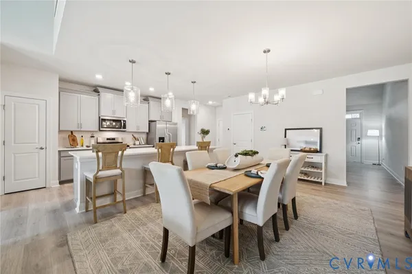 a dining room with furniture and wooden floor