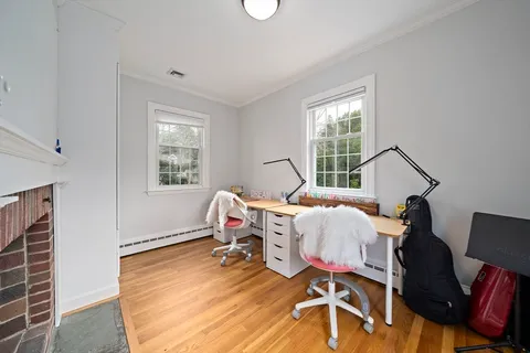 a room with wooden floor and furniture