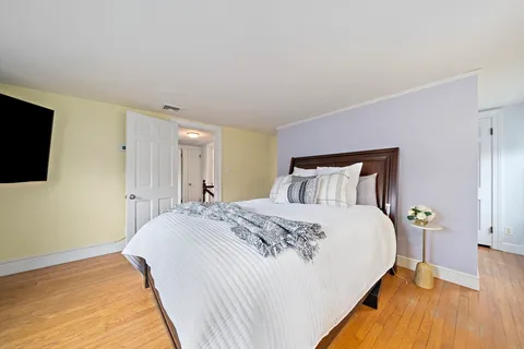 a bedroom with a bed and a flat screen tv