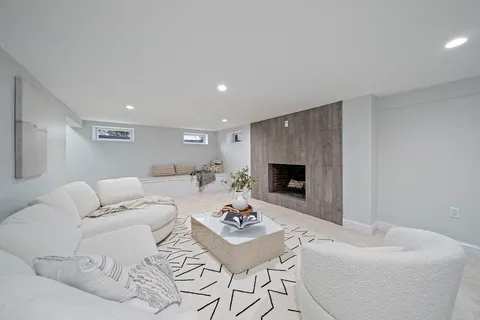 a living room with furniture and a fireplace