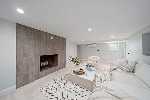 a living room with furniture fireplace and a fireplace