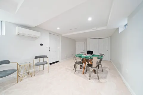 a dining room with furniture and a potted plant