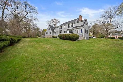 an aerial view of a house with garden space and street view