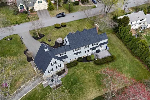 an aerial view of a house with a yard