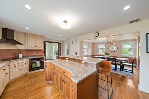 a open kitchen with stainless steel appliances granite countertop a stove and cabinets