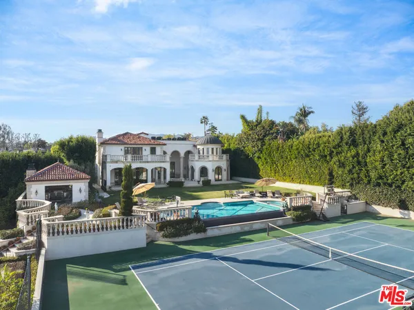 a view of a house with a garden and deck