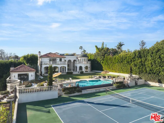 a view of a house with a garden and deck