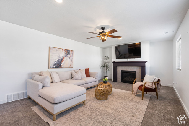 3456 South Linden Way Syracuse, UT 84075 - Photo 3 of 50 Carpeted living area featuring a glass covered fireplace, a ceiling fan, and baseboards