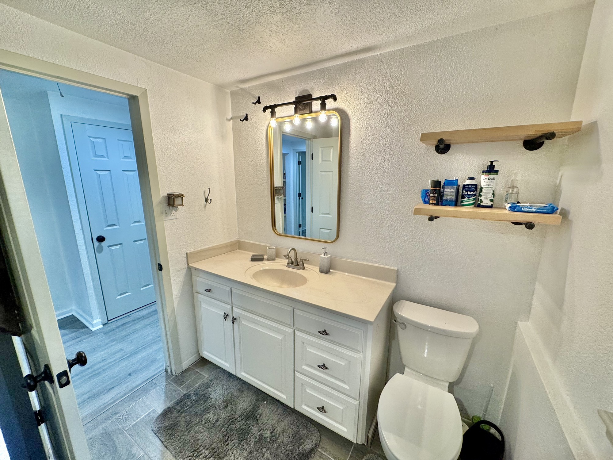 11837 13th Street Santa Fe, TX 77510 - Photo 11 of 20 a bathroom with a toilet sink and mirror