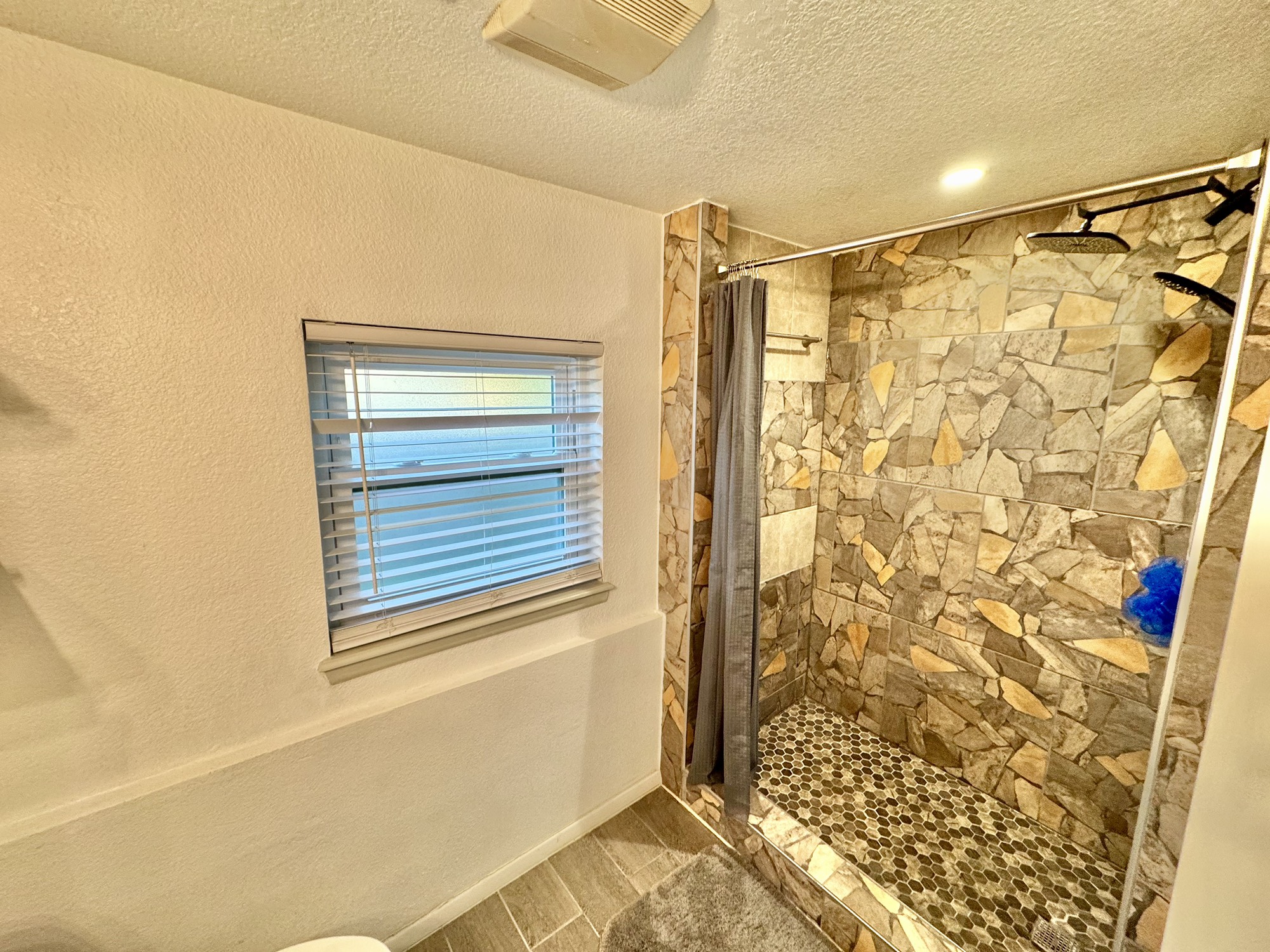 11837 13th Street Santa Fe, TX 77510 - Photo 12 of 20 a bathroom with a shower curtain and a window