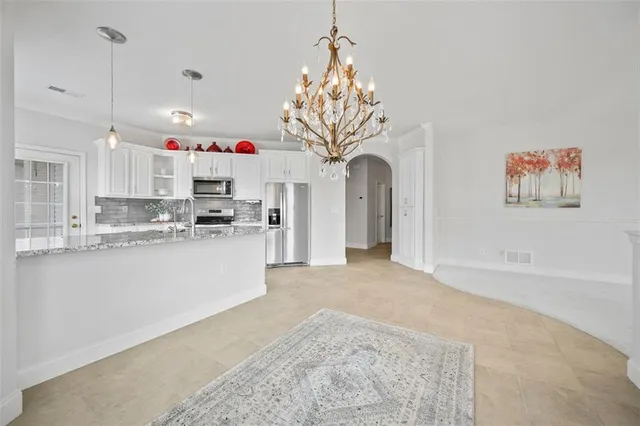 a view of kitchen with furniture and refrigerator
