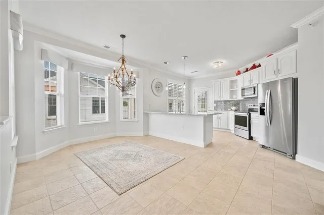a view of an room with windows and chandelier