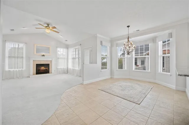 a view of an empty room with a fireplace and a window