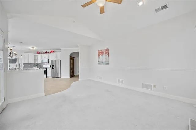 a view of empty room with wooden floor and window