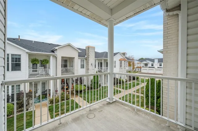 a view of a white house with a big yard and large trees