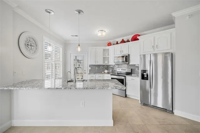a bathroom with a granite countertop sink and a large mirror