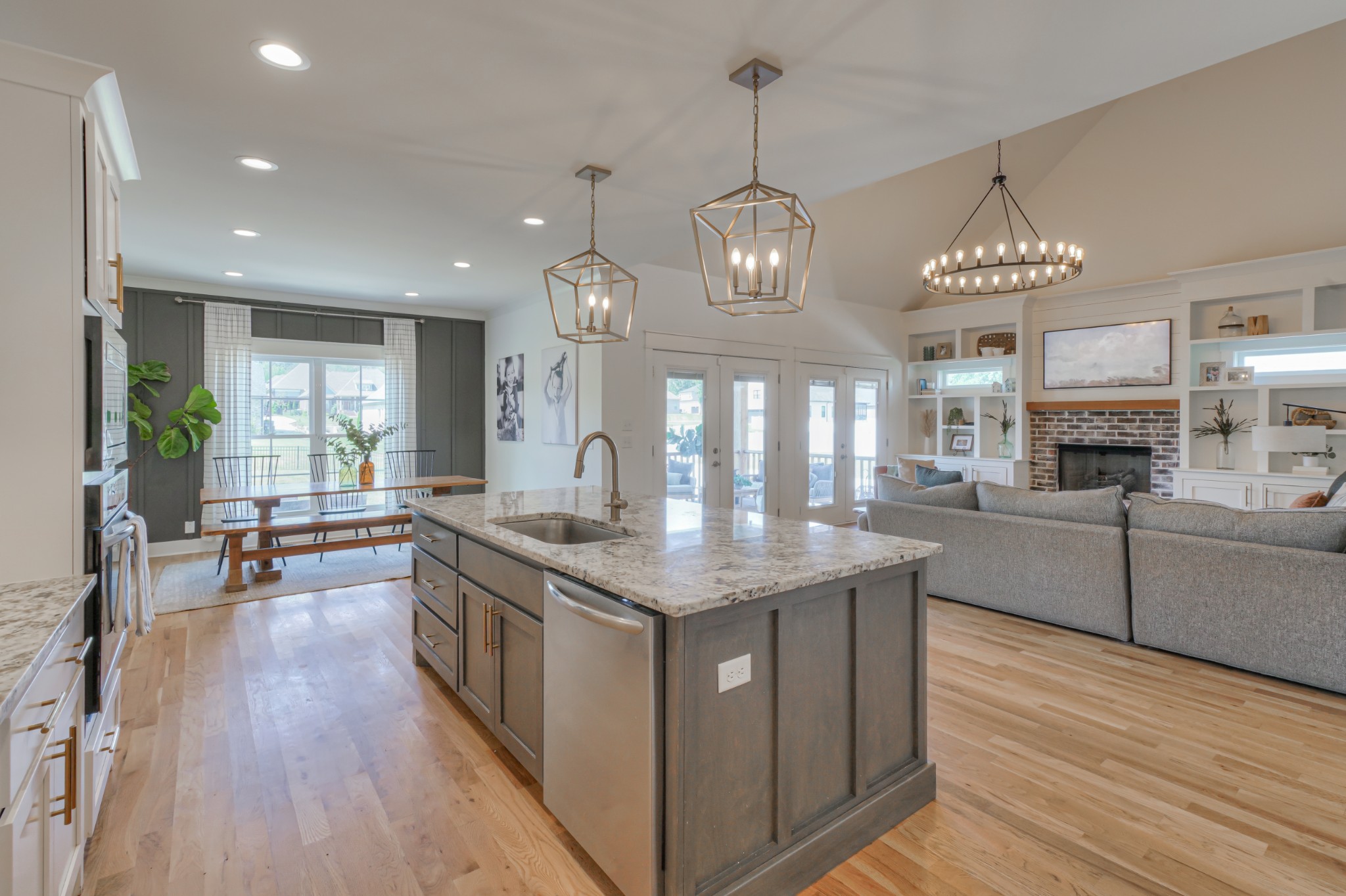 7774 Santos Drive Murfreesboro, TN 37129 - Photo 12 of 42 a kitchen with stainless steel appliances granite countertop wooden floors and white cabinets