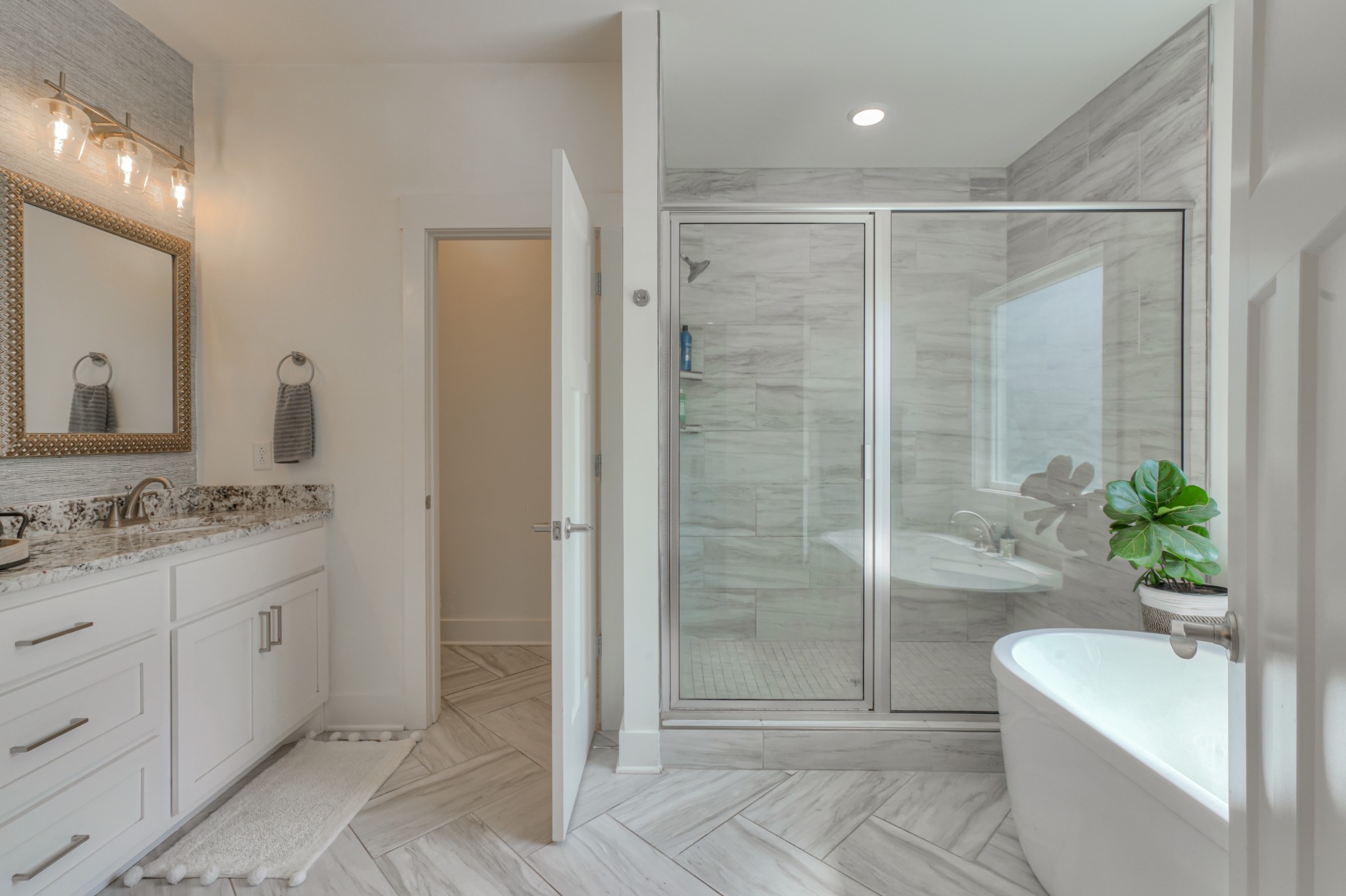 7774 Santos Drive Murfreesboro, TN 37129 - Photo 19 of 42 a bathroom with a granite countertop sink a toilet a mirror and shower