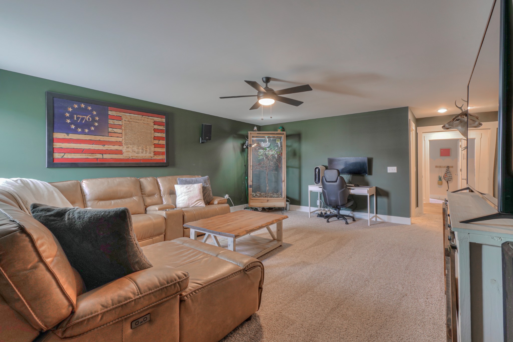 7774 Santos Drive Murfreesboro, TN 37129 - Photo 32 of 42 a living room with furniture a chandelier and a flat screen tv