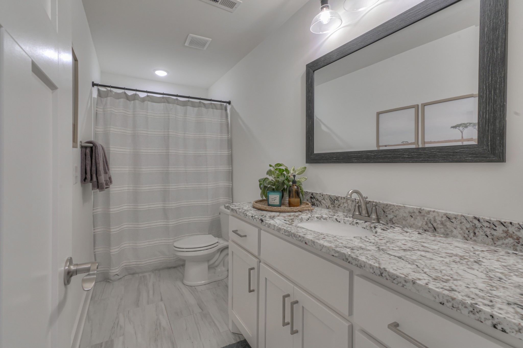 7774 Santos Drive Murfreesboro, TN 37129 - Photo 33 of 42 a bathroom with a granite countertop sink a toilet and a mirror