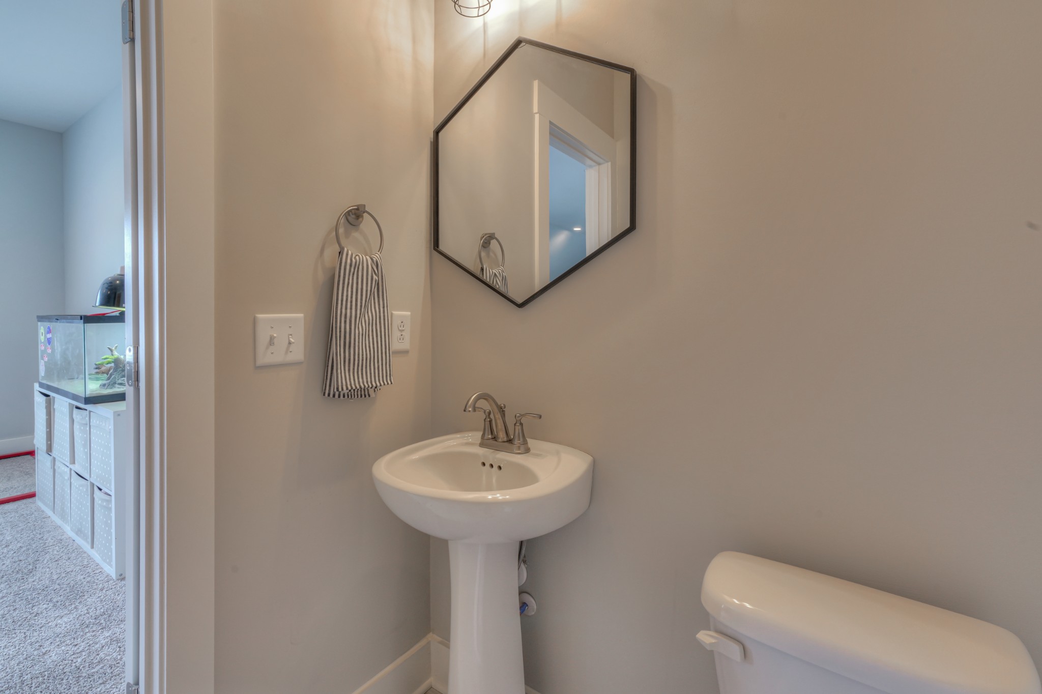 7774 Santos Drive Murfreesboro, TN 37129 - Photo 37 of 42 a bathroom with a toilet a sink and mirror