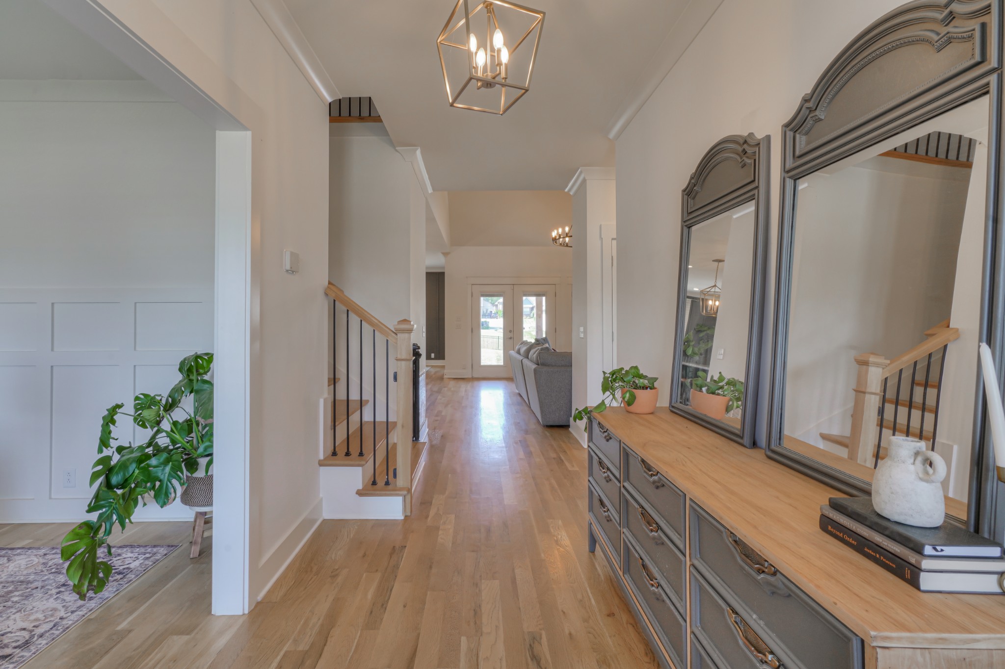 7774 Santos Drive Murfreesboro, TN 37129 - Photo 4 of 42 a view of a hallway with wooden floor and a chandelier