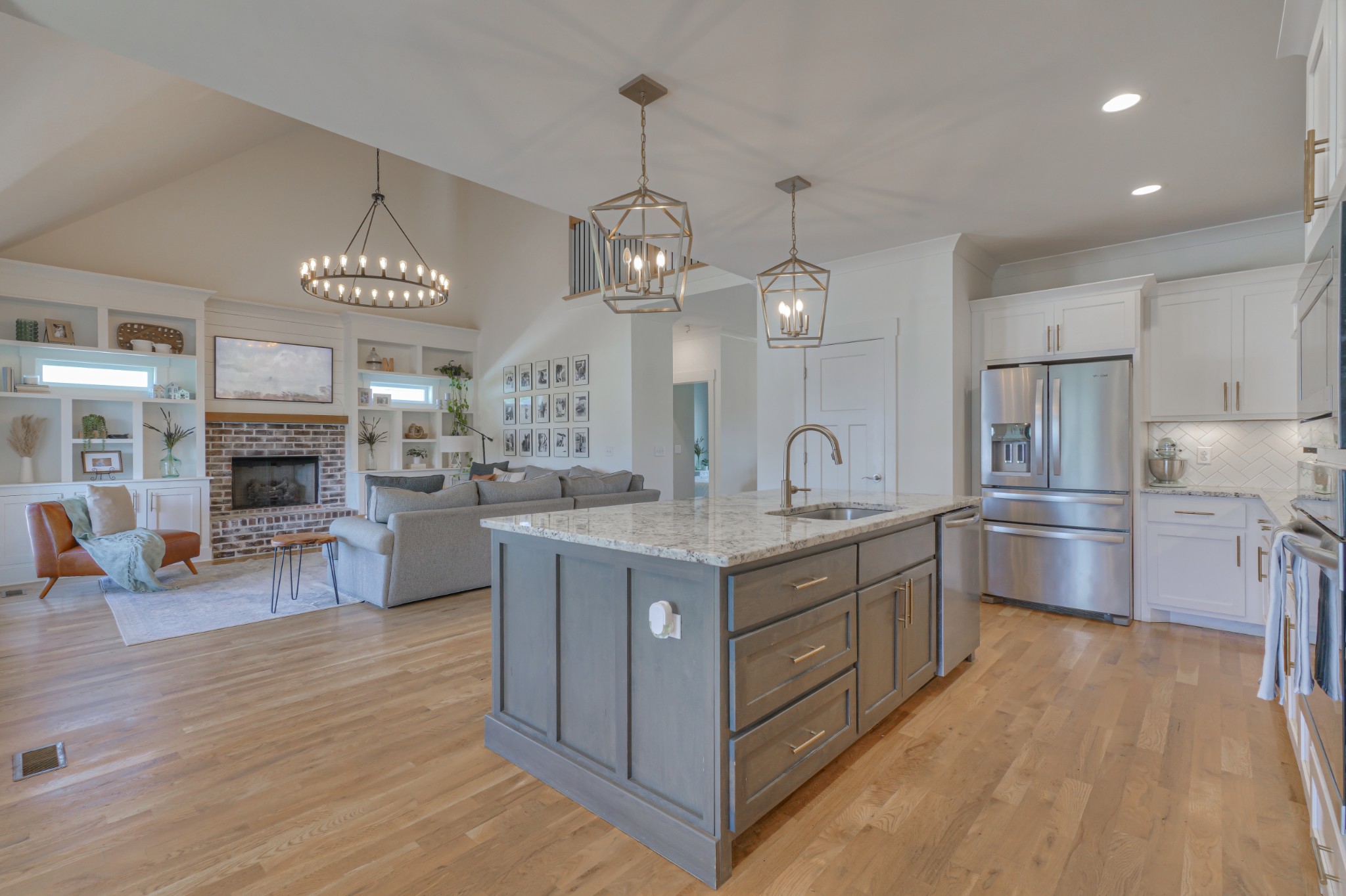 7774 Santos Drive Murfreesboro, TN 37129 - Photo 9 of 42 a kitchen with stainless steel appliances granite countertop a sink cabinets and wooden floor