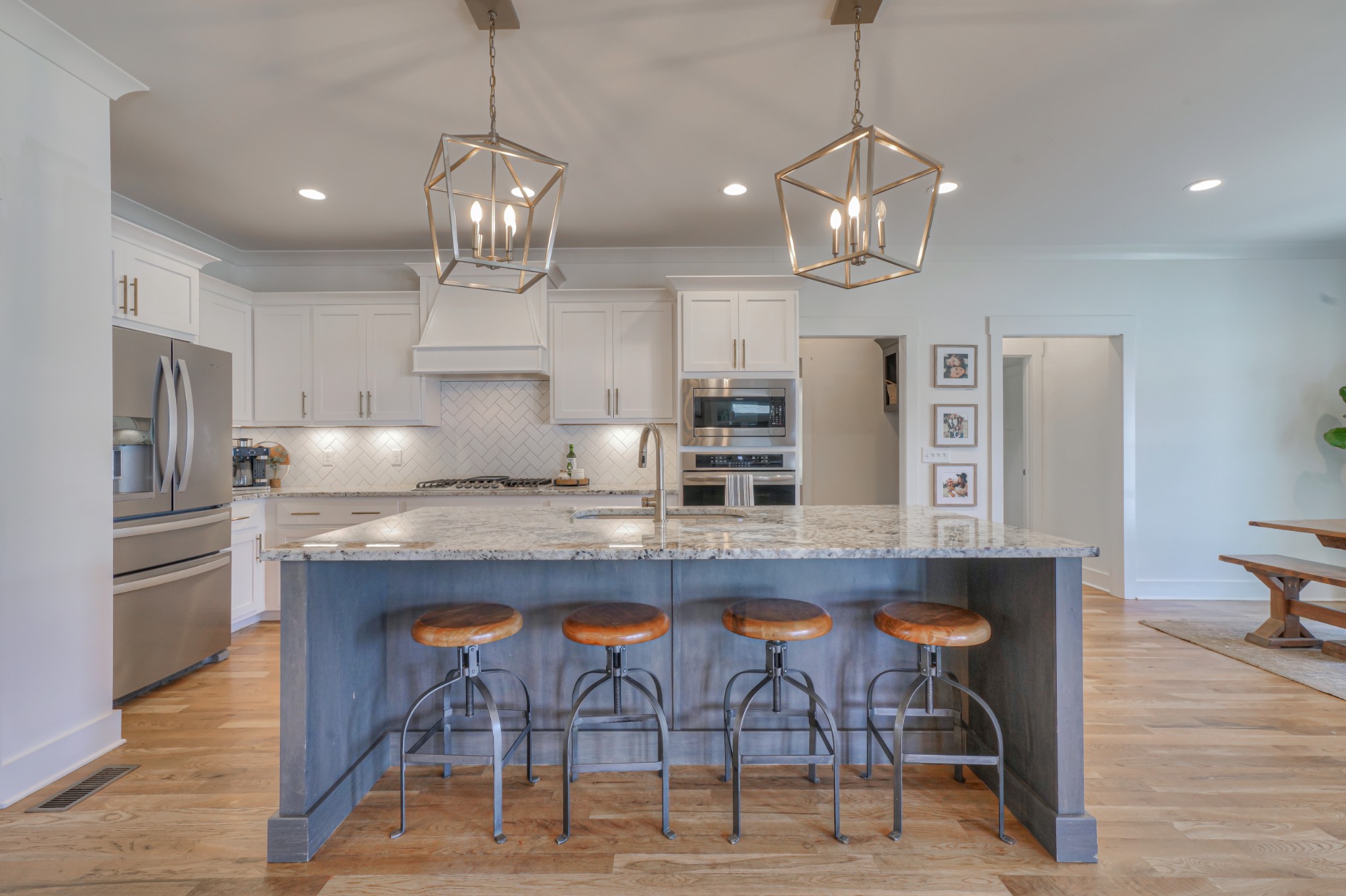 7774 Santos Drive Murfreesboro, TN 37129 - Photo 10 of 42 a kitchen with granite countertop a table chairs stainless steel appliances and wooden floor