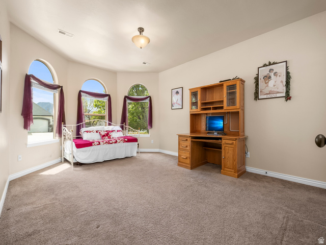 255 East 1200 North Mapleton, UT 84664 - Photo 23 of 37 Room featuring three arched windows, recessed lighting, and neutral-toned carpeting