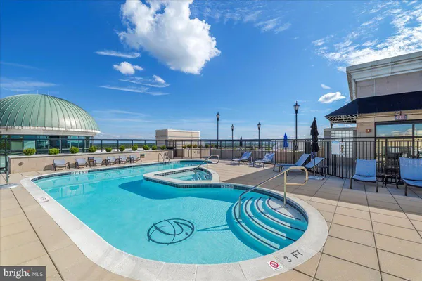 a view of a swimming pool with outdoor seating
