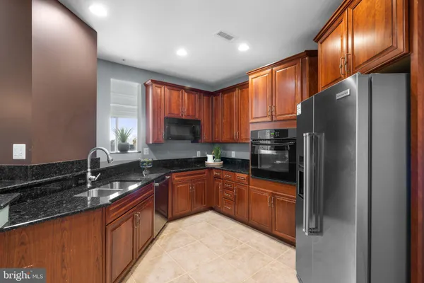 a kitchen with sink a window and appliances